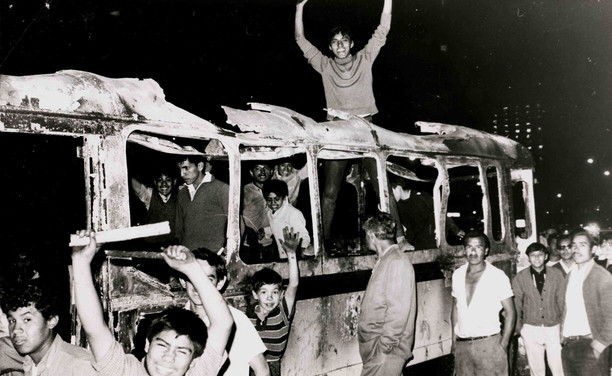Students in a burned bus. By Marcel·lí Perelló - my personal archive, Public Domain, https://commons.wikimedia.org/w/index.php?curid=2471104