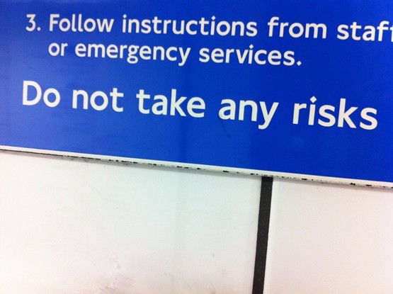 less perfection more risky learning: London Underground sign that says: 3. Follow instructions from staff or emergency services. Do not take any risks