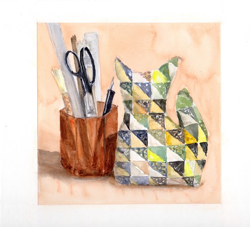Watercolor painting, square format: at left a transparent orangey-brown hexagonal cup holding a couple hake brushes, paper scissors with black handles, a stick, a ruler, and a black pen holder with a script nib. To the right is a stuffed small seated cat made out of many half-square triangles, one side light and the other dark. The background is a mottled peach color.