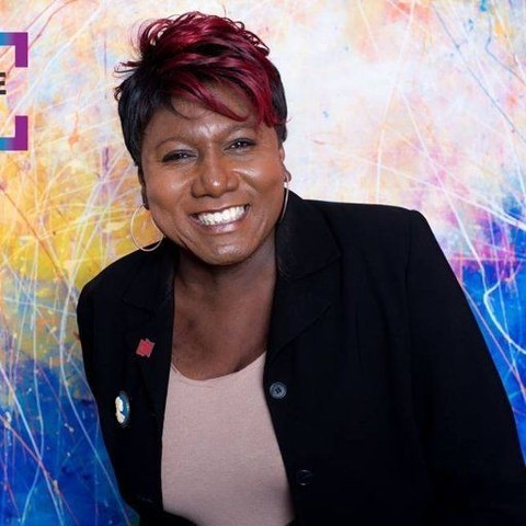 Monica Roberts, a Black trans woman with short hair, smiling into the camera