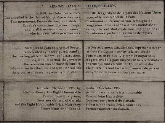 Peace memorial in Ottowa, text in English (right justified) & French (left justified) on the same number of lines. The French is longer