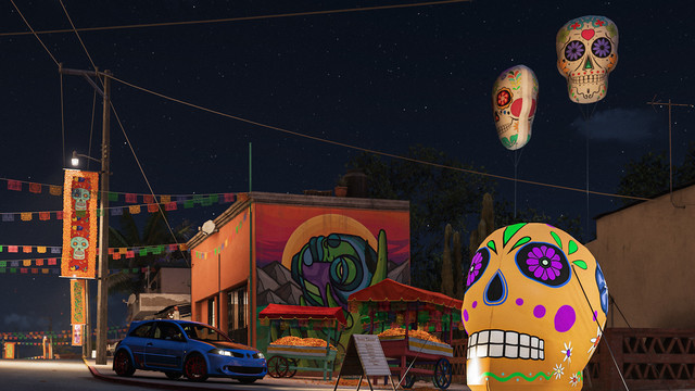 A blue 2008 Renault Mégane R26.R with red wheels stands in front of the Star 27 Mural in Forza Horizon 5 at night, surrounded by Día de Muertos-themed decorations.