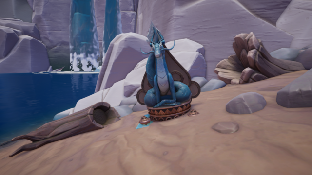 A screenshot from Palia of a sandy beach against a cliffside. Bits of rock and driftwood are scattered about. A waterfall is in the distance.

In the center of the image is the statue of a blue dragon on a small circular pedestal. Two small incense burners are on either side of it.