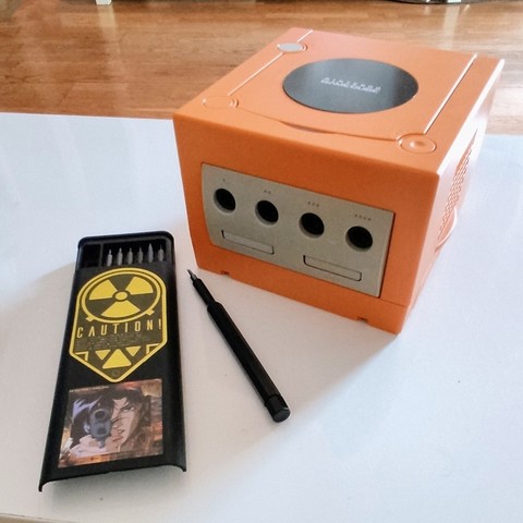 An orange aftermarket housing applied to a Gamecube.
