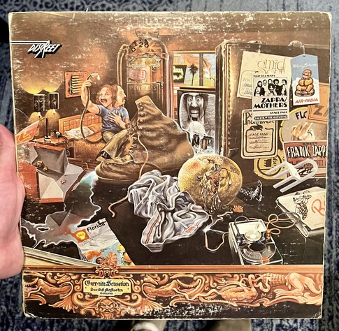 The Mother’s of Invention overnight sensation album cover featuring a surreal painting on the cover