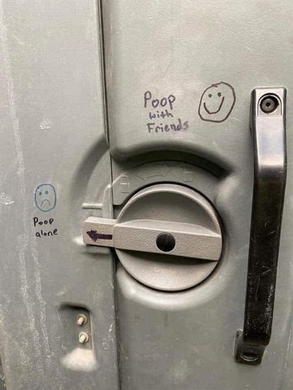 The door fastener of a Porta Potty is labeled Poop Alone and Poop With Friends.