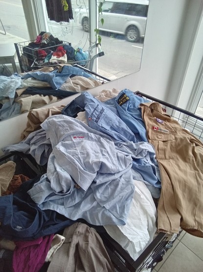 a pile of shirts including several old uniforms like OCTranspo,
