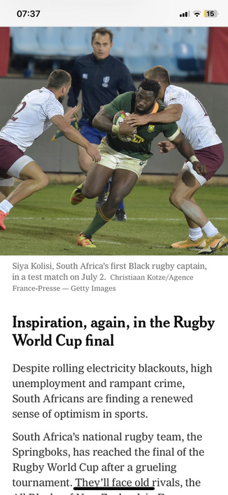 Photo of a black rugby player holding a rugby ball wearing a green and yellow outfit (the colours of the South African team) running past players on either side wearing white and burgundy outfits. Below the text: Siya Kolisi, South Africa's first Black rugby captain, in a test match on July 2. Christian Kotze/Agence France-Presse - Getty Images