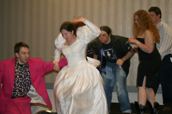 Five actors perform a horror parody in a hotel conference center panel room during a science-fiction convention portraying a groom and bride trying to escape three zombies.