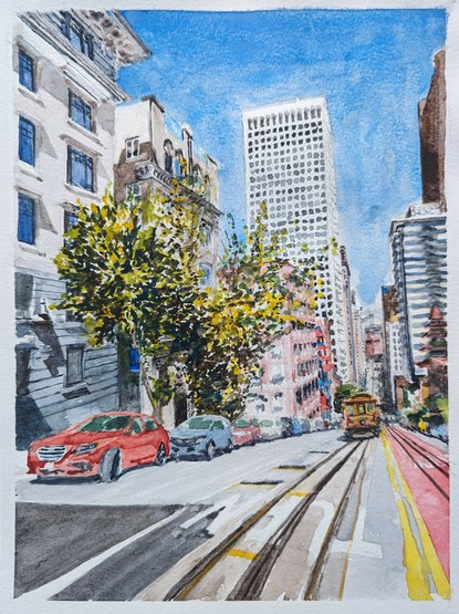 A San Francisco cable car makes the iconic climb up California Street to the top of Nob Hill. To the left, a couple of trees show vibrant spring foliage, almost disguising the apartment building behind them. the background, the Bay Bridge is seen, and, family, East Bay Hills beyond.