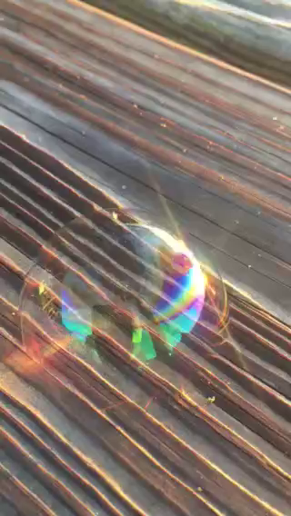Color video of a bubble dancing on a dock in Coastal Carolina along a sea island salt marsh.