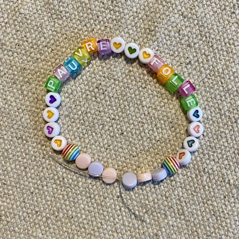 Bracelet of beads, saying pauvre folle (crazy girl)