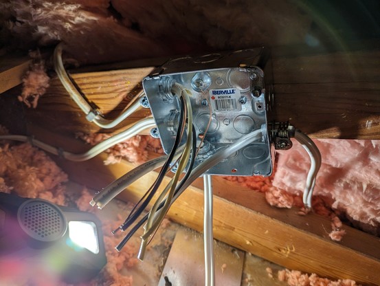 A 4-inch square box with 4 Romex cables coming in from different knockouts. A cover plate is nearby.