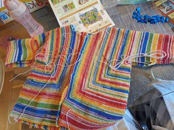 Knitted rainbow cardigan still with finishing to do.