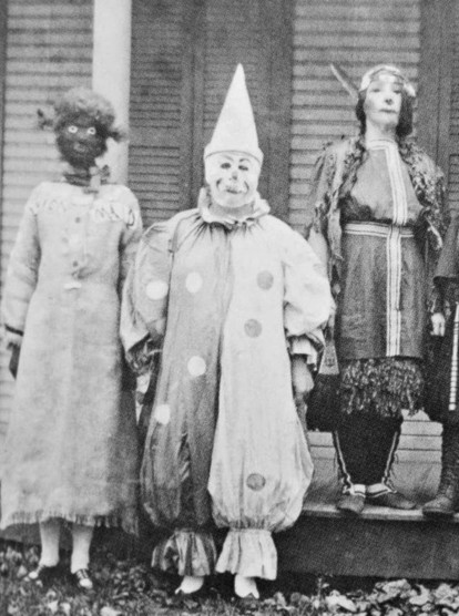 A set of vintage black & white photos of children (adults, maybe?) wearing homemade Halloween costumes. They are very disturbing images, to put it mildly. 

Three people wearing costumes. 

One is wearing a relatively normal-looking dress but their head looks like a dark brown or black Mr Potato Head toy with huge round eyes and a scraggly mouth with a light-colored Pippi Longstockings wig. He or she may have a corncob pipe in their mouth. 

Another is dressed as a scary clown, complete with pointy hat and a white face and dark (red?) nose and lips. 

The third may be dressed up as a gypsy but it's hard to tell in the photo. They're wearing a dress (or blouse and skirt) that are part-solid colored and part-patterned. Their face is covered in white makeup and they have thin, twisted hair hanging down past their shoulders. It's probably a wig but it's hard to know for sure.