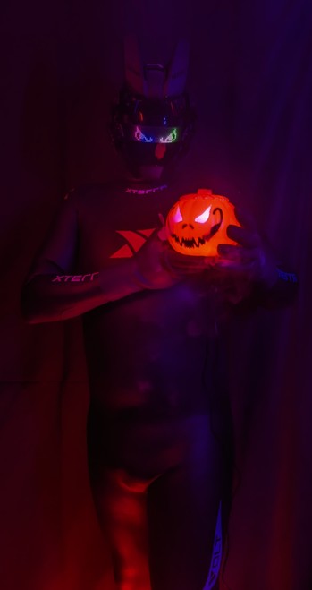 Me being covered from head to toe in smoothskin neoprene holding a plastic pumpkin which emits water vapor.