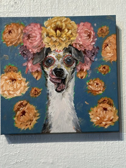 An adorable dog with tongue out, wearing a crown of flowers.