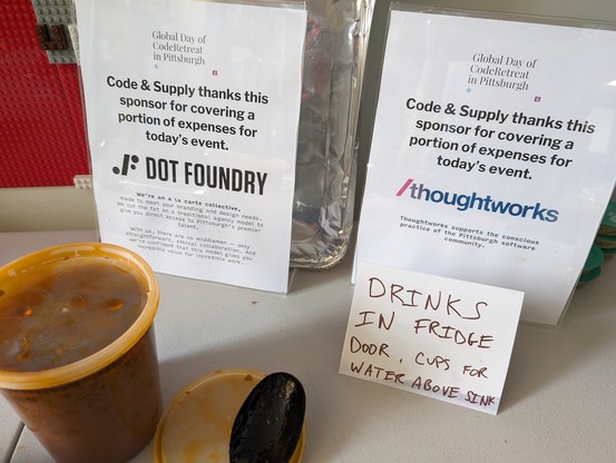 Signs at Code & Supply thanking DOT FOUNDRY and THOUGHTWORKS for sponsoring Global Day of Coderetreat 2023 in Pittsburgh