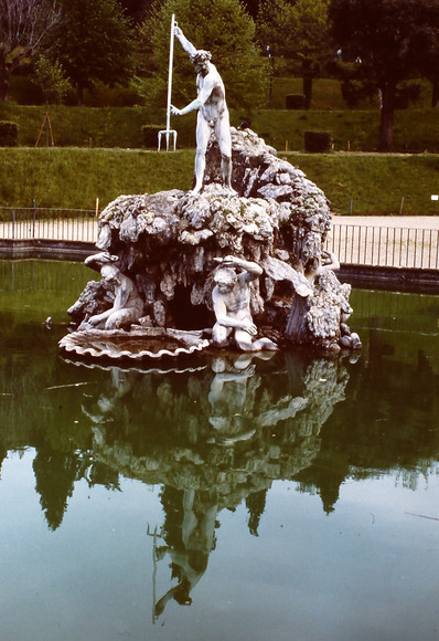 Statue of Neptune about to spear something in a garden pond.