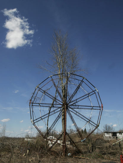 Color image of a bared tree in the autumn, in a former amusement part in Northeast Ohio, USA, growing up through an old Ferris Wheel.