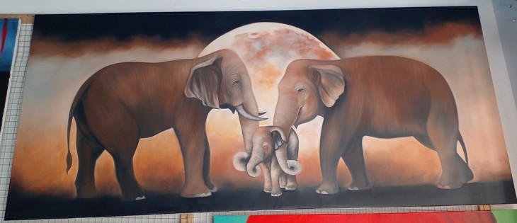 a painting, it is horizontal-shaped, two elephants are facing each other, seen from the side, one with trunks and one without, the background is tan and dusty, the moon behind them, between their trunks is their baby, all the elephants are brown, the baby loves the feeling of its parents trunks rubbing it