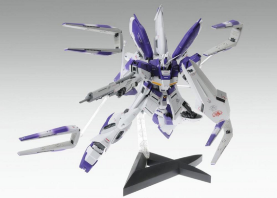 a model of a gundam, a giant robot fighting machine, its body is white with purple decals and stripes of color on it, it is getting its remote weapons ready, it holds a laser rifle and a large shield, the figure is in an action pose