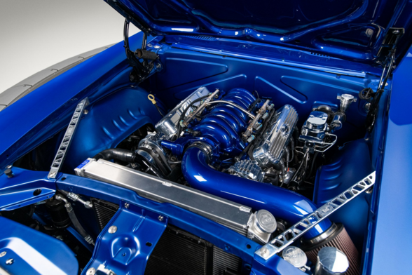the hood is up, the engine inside, blue and chrome shining