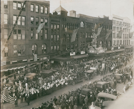 Black and white image of downtown Akron, Ohio, November 11, 1918, wiht parades and citizens celebrating the end of hostilities and WWI with the signing of the Armistice.