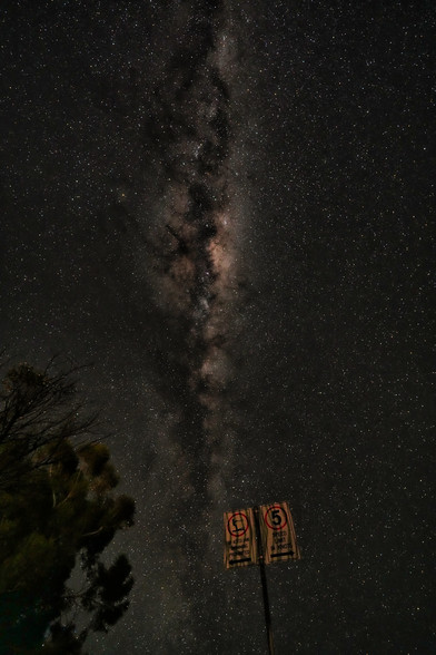 A milkyway right in the centre of the frame arises from a lakeside sign for no standing 

Lake Boga Australia