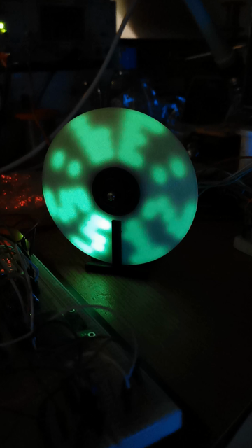 Rotating glow in the dark disk. 5 uv leds writing with light on the rotating disk numbers in pattern of an clock