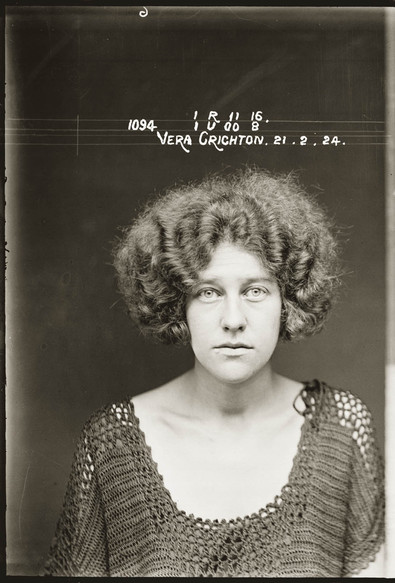 mugshot of young woman with sorrowful eyes and wild hair