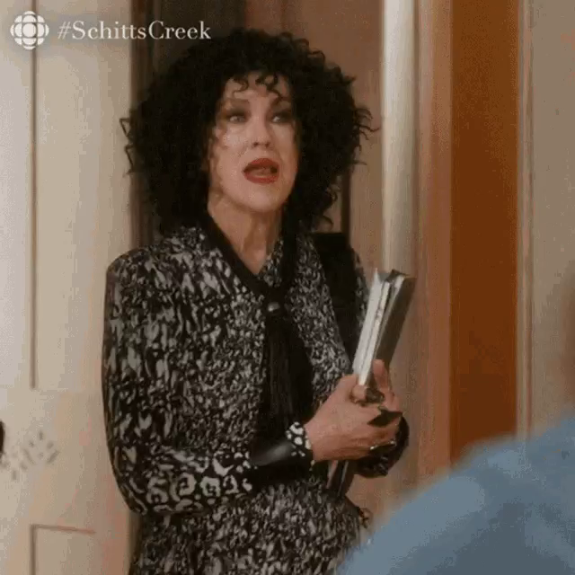 Schitts Creek, Moira Rose with black curly hair entering a room and saying:
"I have questions"