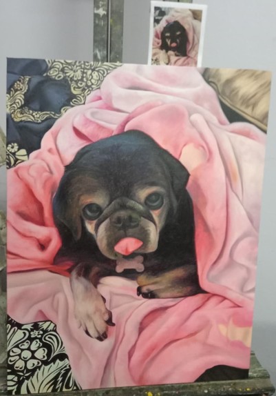 all the blankets are painted in, the pug is wrapped in a pink one that is on top of a black and white floral one
