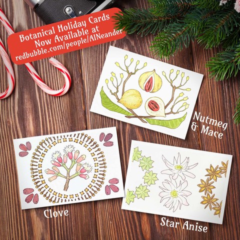 Three greeting cards featuring botanical designs sit on a wooden table decorated with a pine bough and candy canes.
