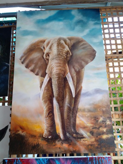 a painting of an elephant, standing on the brown earth, grasses sticking up, blue sky with clouds, the elephant is facing the viewer