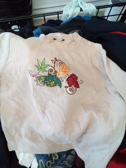 a sweatshirt embroidered with leaves