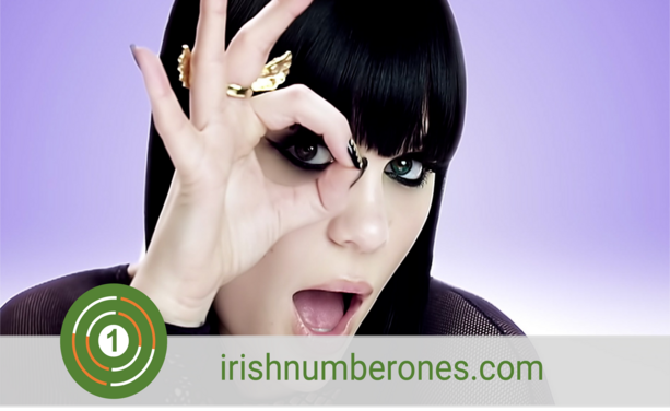 A woman with black bobbed hair looks through her fingers in an 'O' shape