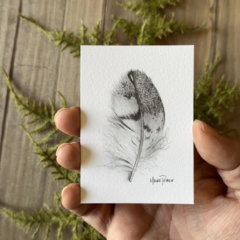 Hand holding a baseball card sized fine art print.