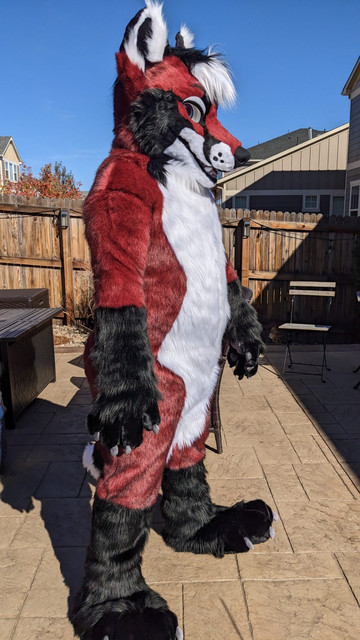 Red, black, and white fox fullsuit, 3/4 front view