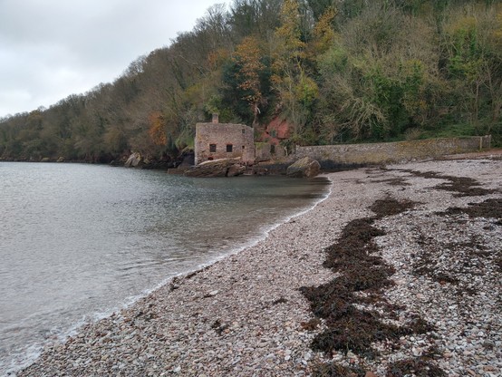 Looking at an old broken building by the beach at Elberry Cove, Devon.