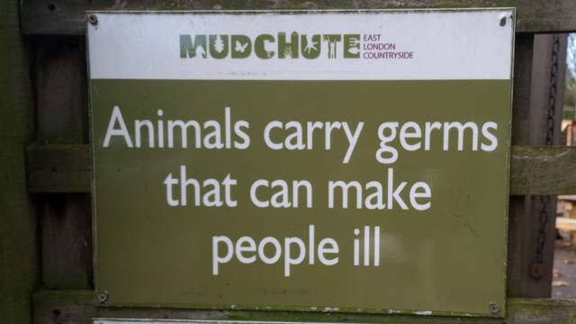A sign that reads, implausibly, "Mudchute East London Countryside" followed by the heartwarming advice that "Animals carry germs that can make people ill"