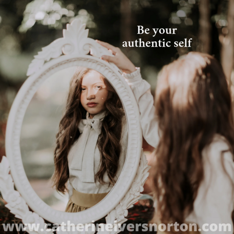A girl’s contemplative face is reflected in a mirror. The caption reads, "Be your authentic self."