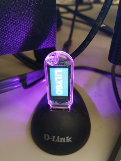 Lilygo T-Dongle S3 pluged into a usb port display with the demo that came preloaded on the device