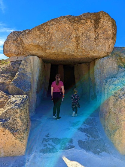 Little explorers, entering the darkness of the Dolmen de Menga, Antequera, 3750–3650 BCE.
On the way out, they face towards Lovers' Rock, and the small cave now known as Goat Butcher's Shelter, with its cave paintings from an earlier period of around 3900 BC.