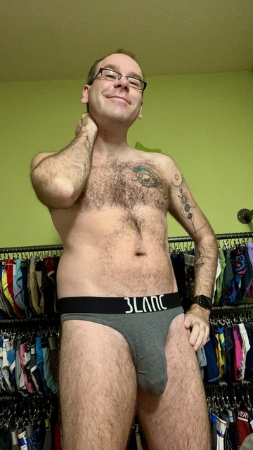 Hairy gay guy wearing grey Blanc briefs with black waistband