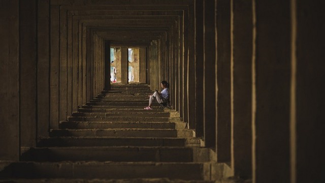 Person sitting in a very deep chamber of some sort.