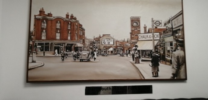 Painting dated 1955 looking from Dartmouth Road towards the old railway station. Lots of pedestrians but only one car.