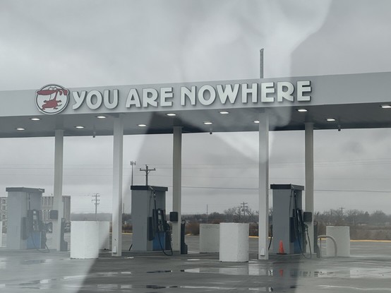 Gas station slogan above pumps: “You are nowhere.”
