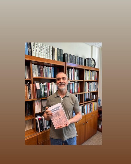 Author James St. Andre holding a copy of his new book, Conceptualising China through Translation