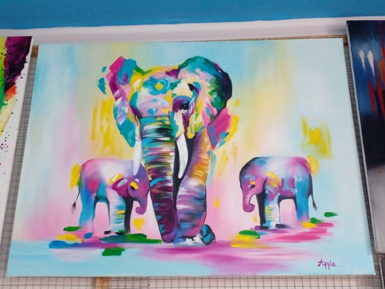 a painting of three elephants, done in an impressionist style with blues, purples, yellows, and some blacks , one elephant is large with tusks, the other two are smaller younger ones